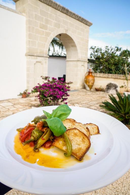 a white plate of food on a table at Masseria Borgo Santuri in Ostuni