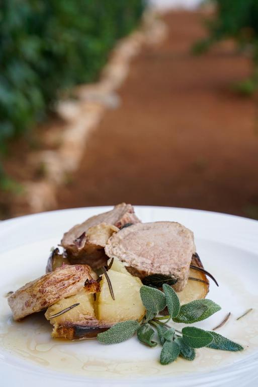 a plate of food with a sandwich on top of it at Masseria Borgo Santuri in Ostuni