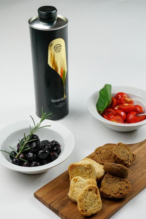 a table with a plate of bread and a bottle of wine at Masseria Borgo Santuri in Ostuni
