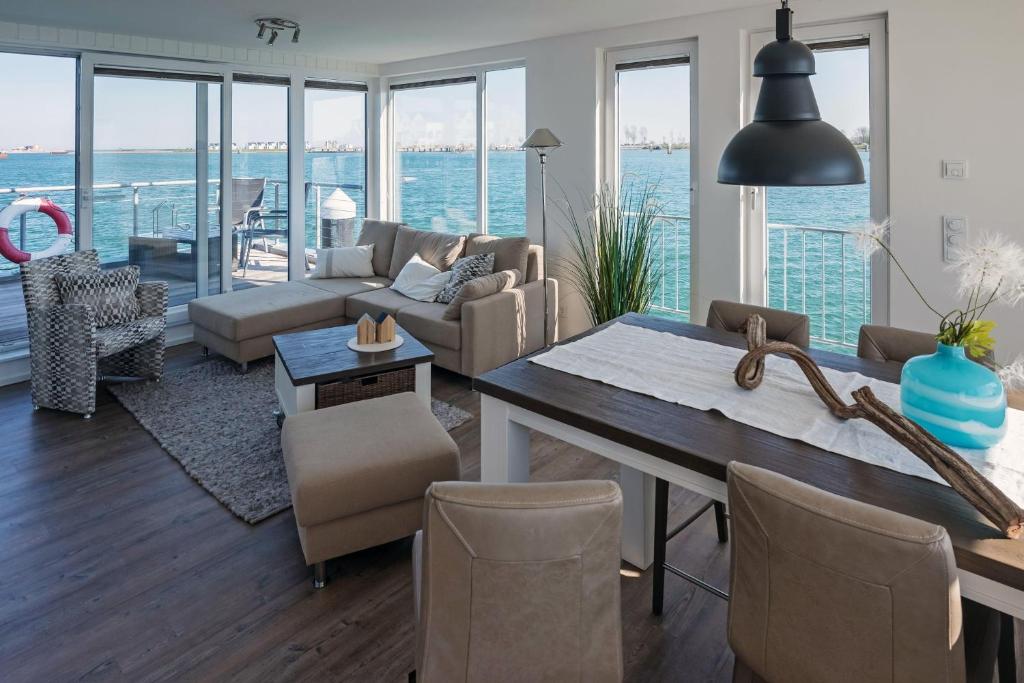 a living room with a view of the ocean at Hausboot ANTARES ONE by Seeblick Ferien ORO in Olpenitz