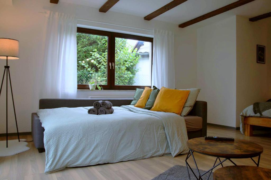 a bedroom with a bed with a teddy bear on it at Studio-Apartment mit Garten, Parkplatz & Küche in Offenburg