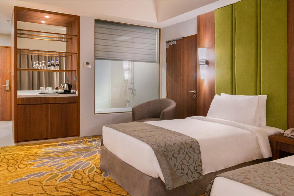 Postel nebo postele na pokoji v ubytování Zenith Hotel Cameron