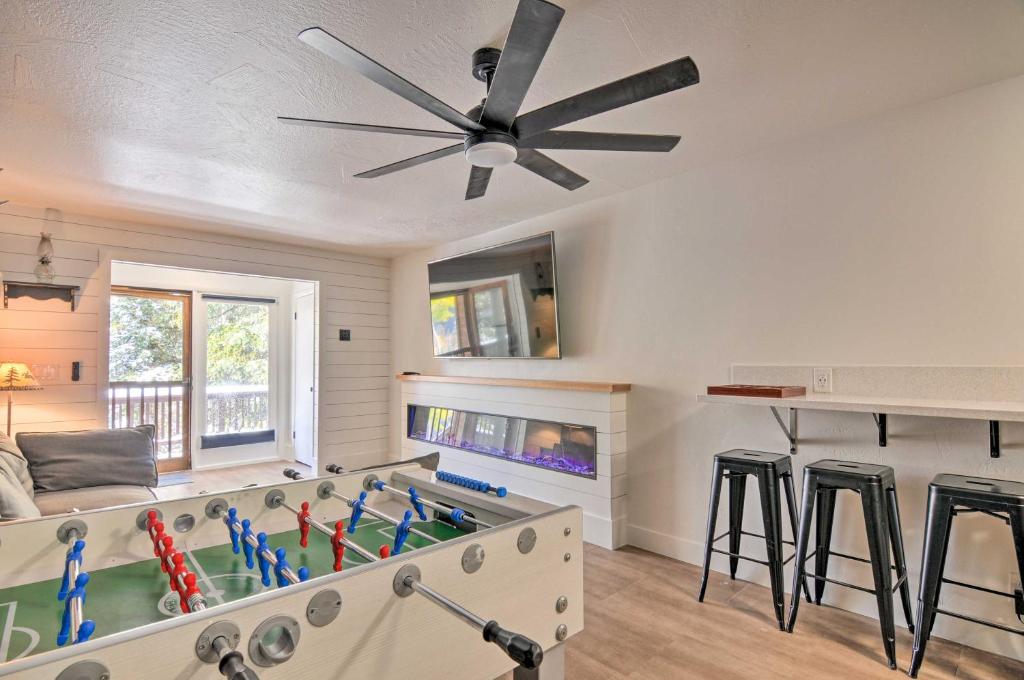 a living room with a ceiling fan and a pool table at The Cottages Sweet Skiiers Escape On The Resort! in Beaver