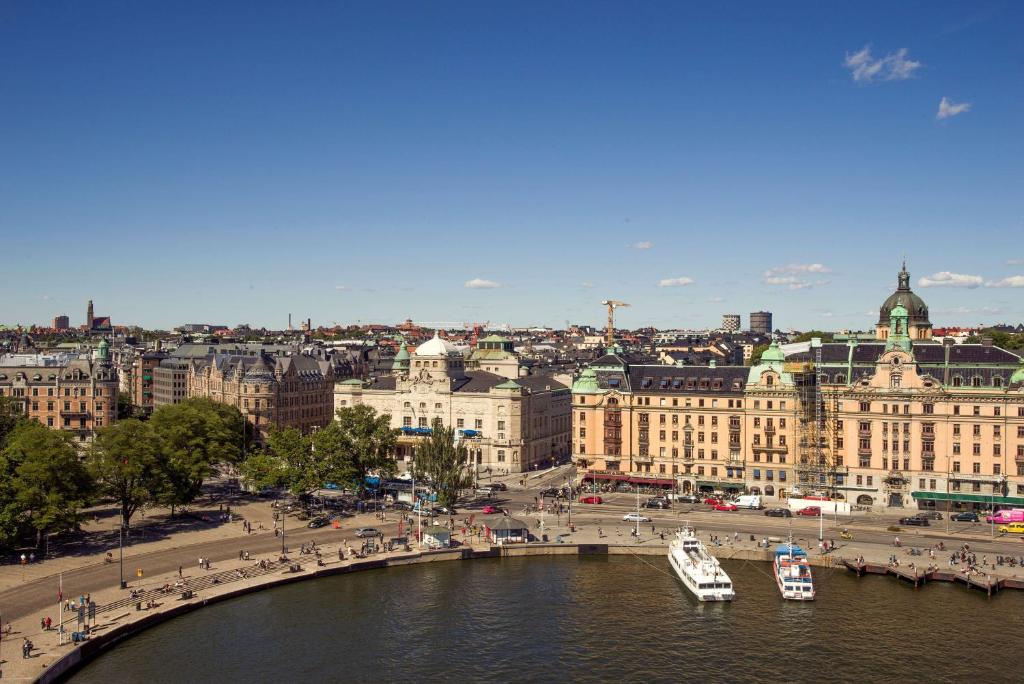 a view of a city with boats in the water at Radisson Collection, Strand Hotel, Stockholm in Stockholm