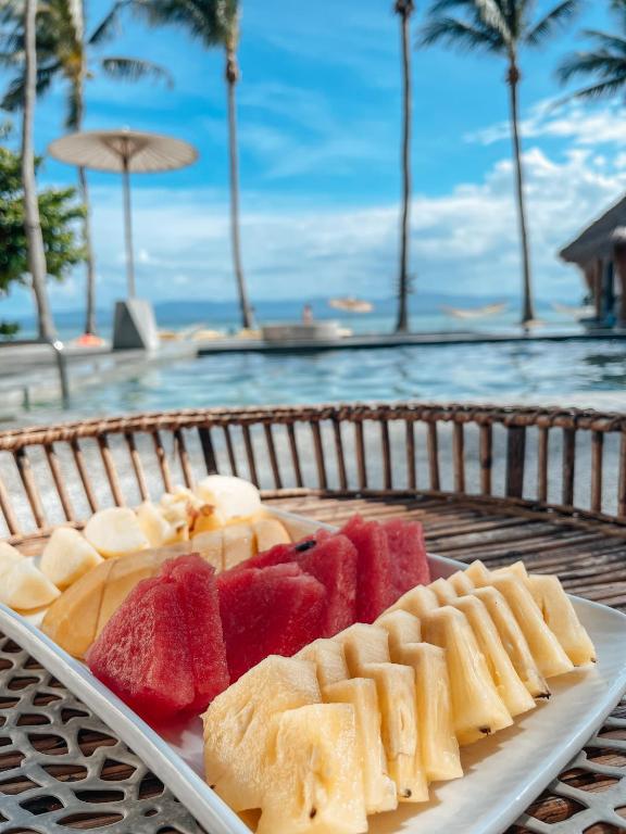 a tray of food on a table next to a pool at Sea Love Beach Bar & Bungalows in Ban Tai