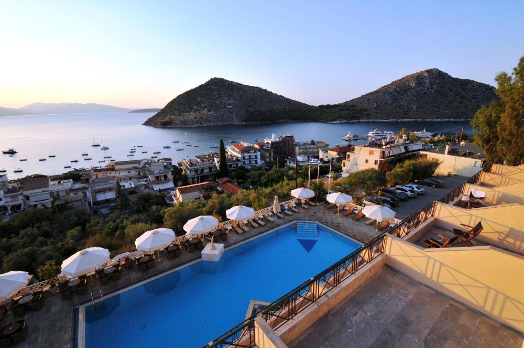 an aerial view of a resort with a pool and the ocean at King Minos Hotel in Tolo