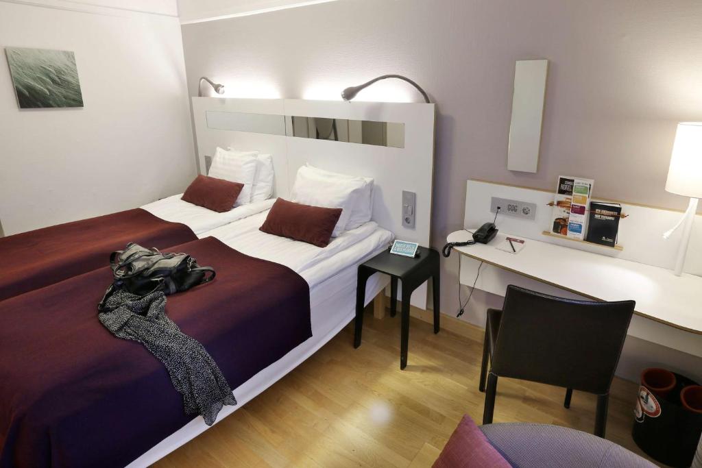 A bed or beds in a room at Scandic Uplandia