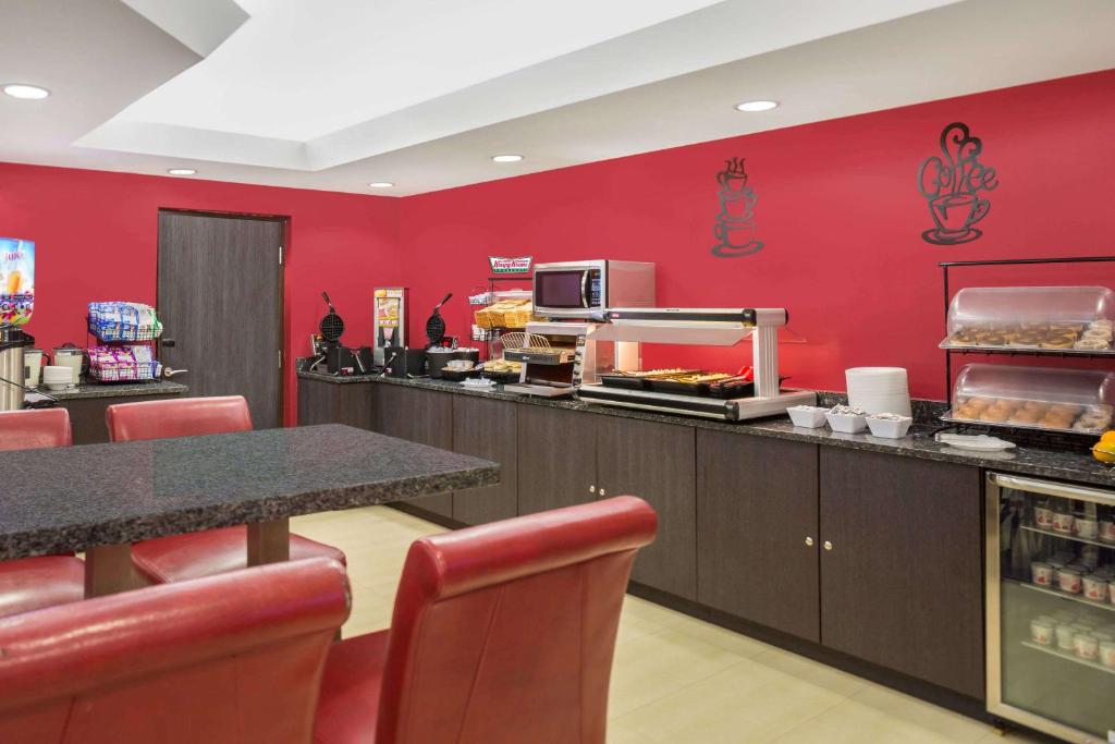 a fast food restaurant with a red wall at Ramada by Wyndham Miami Springs/Miami International Airport in Miami