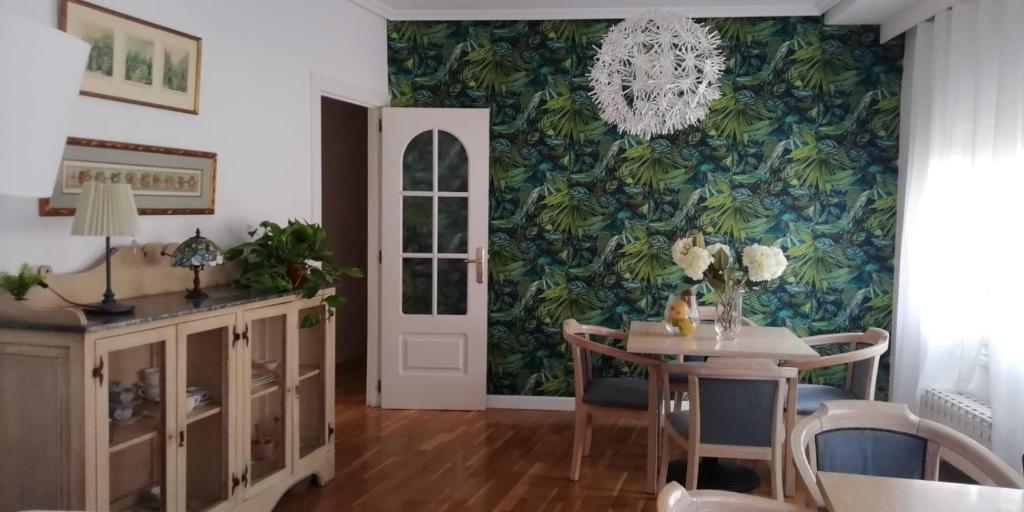 a dining room with a table and a chandelier at Casa Rural Placida in Escalona