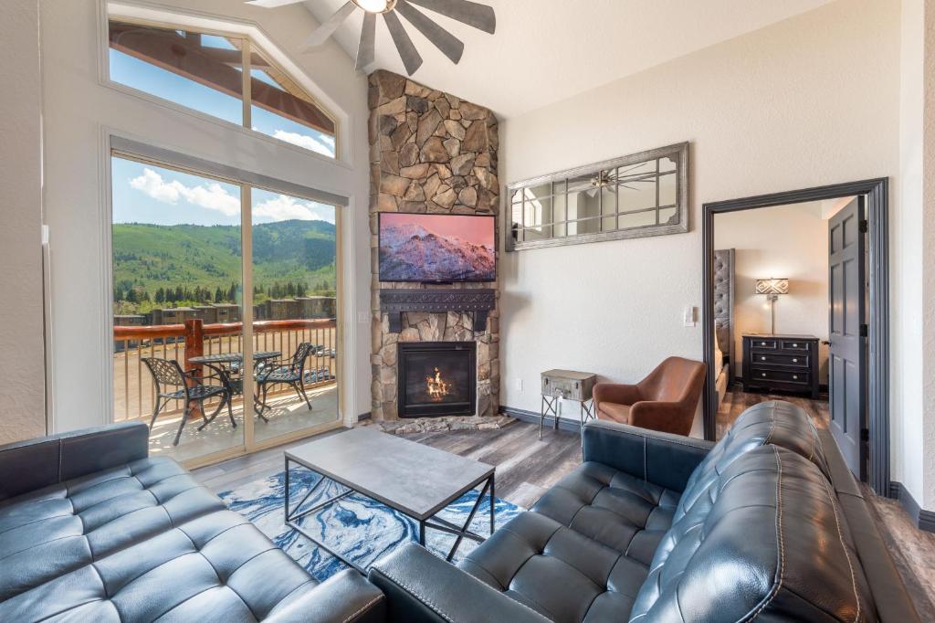 a living room with a couch and a fireplace at Westgate Park City Differentiated Modern Update Top Floor View Deluxe 2 Bedroom in Park City