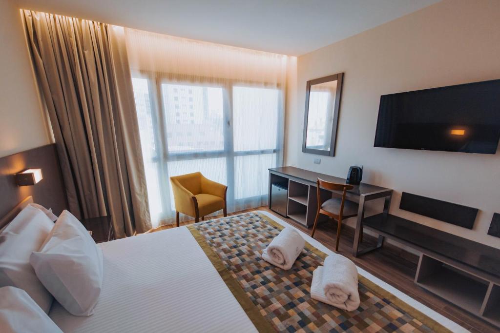 Postel nebo postele na pokoji v ubytování SEC Hotel