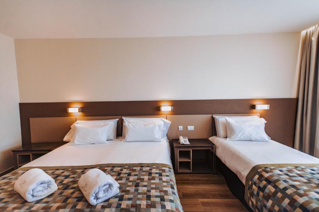 Postel nebo postele na pokoji v ubytování SEC Hotel