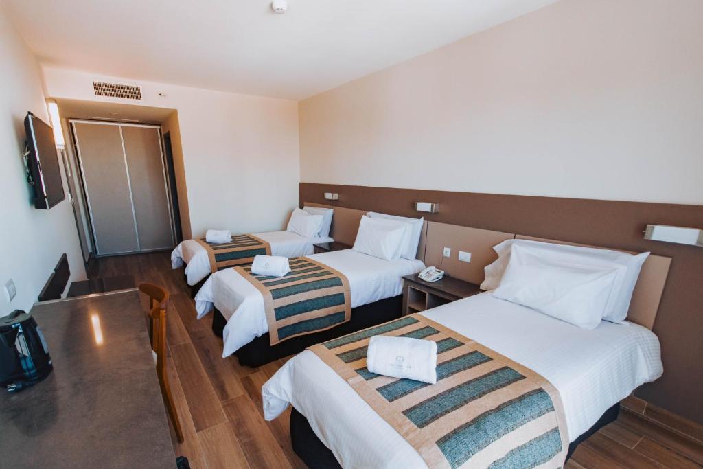 Postel nebo postele na pokoji v ubytování SEC Hotel