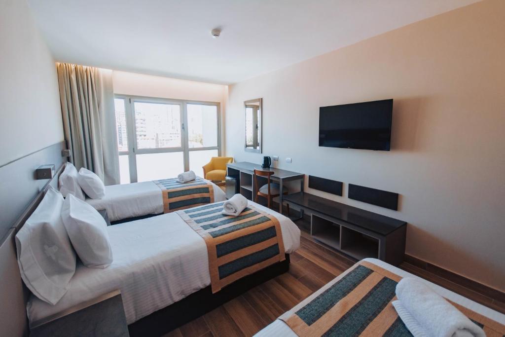 TV a/nebo společenská místnost v ubytování SEC Hotel