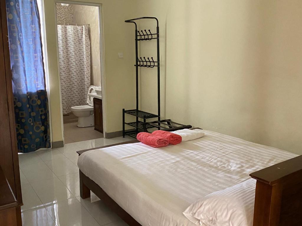 a bedroom with a bed with two towels on it at Diwan Apartment & Chalet in Colombo