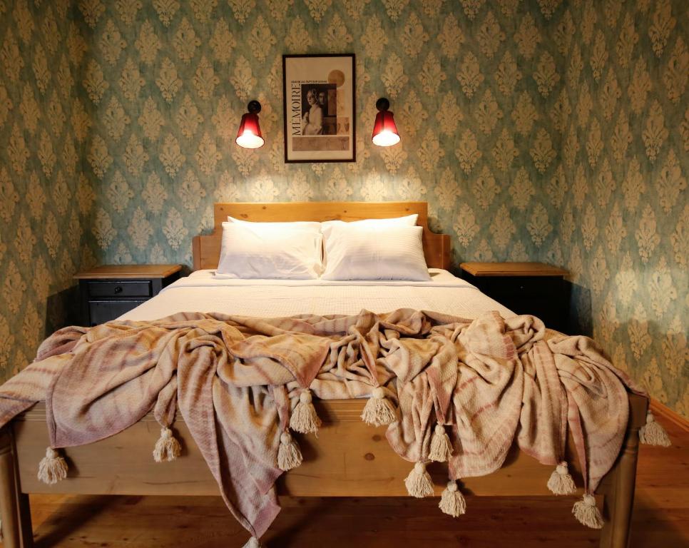 Postel nebo postele na pokoji v ubytování Hotel Memoire Kutaisi