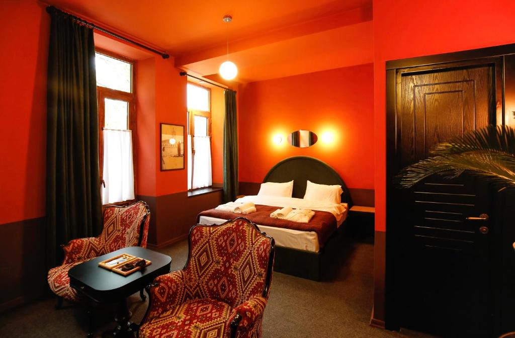 Postel nebo postele na pokoji v ubytování Hotel Memoire Kutaisi