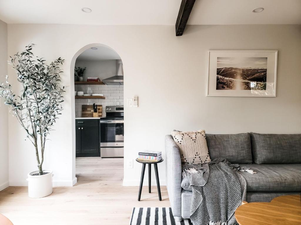a living room with a couch and a kitchen at Black Pearl Unit 1 - Lake Placid, Mirror Lake in Lake Placid