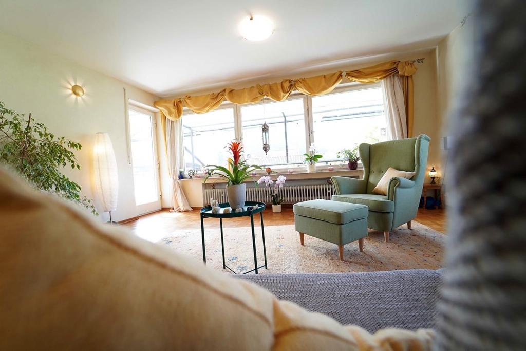a living room with a couch and chairs and a window at Ferienwohnung im Haus Lotus mit großem Balkon und Garten in Bad Urach