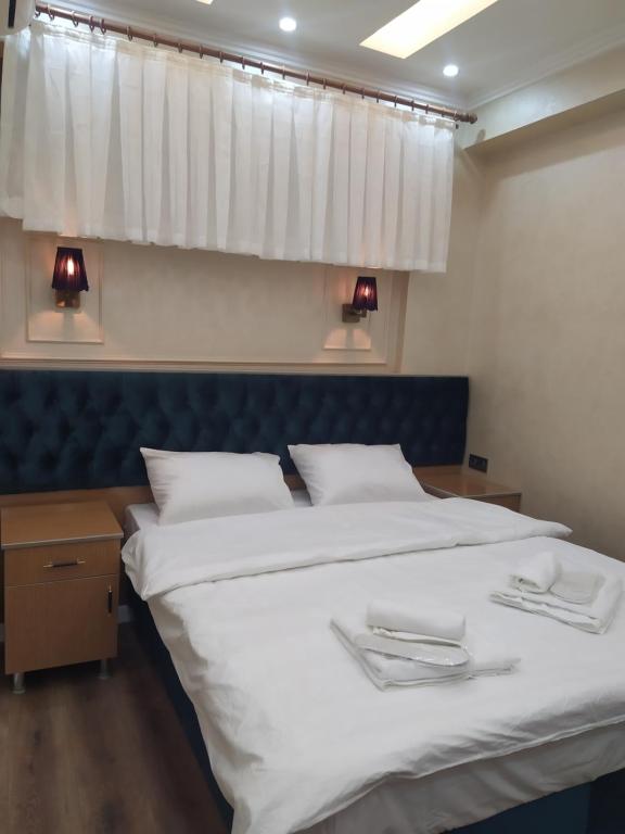 A bed or beds in a room at BoNaMi Hotel