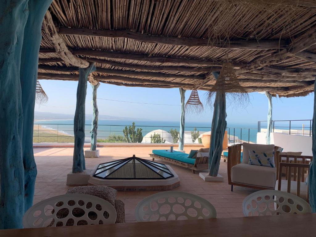 a patio with a view of the ocean at Dar Gecko in Sidi Kaouki
