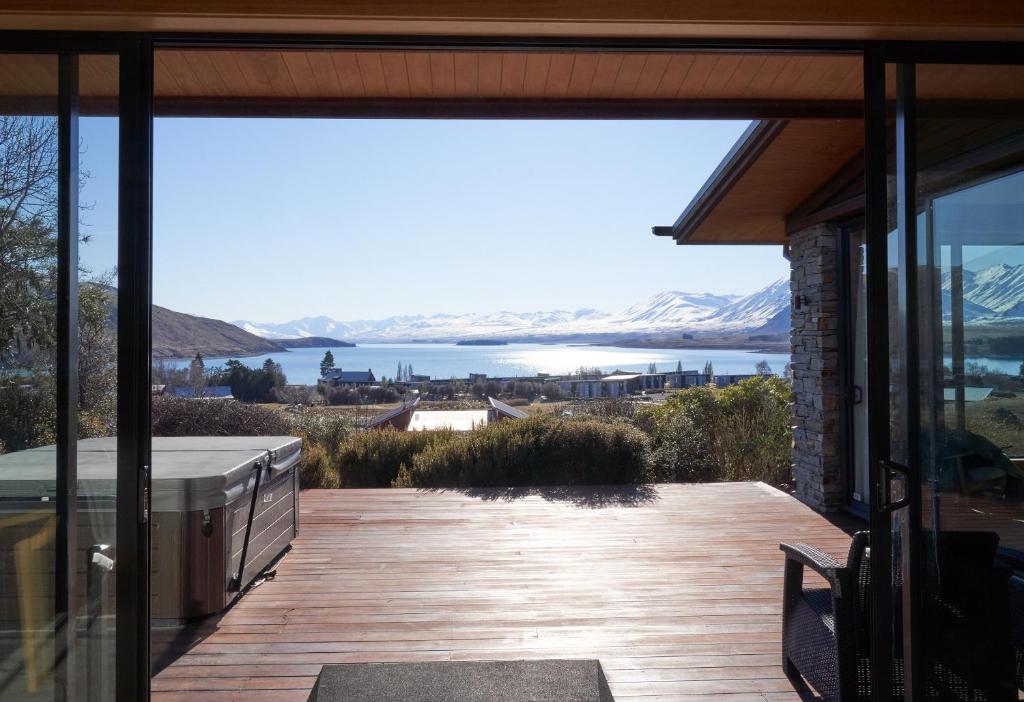 vistas al agua desde la terraza de una casa en Takapō Retreat - Lake Tekapo en Lake Tekapo