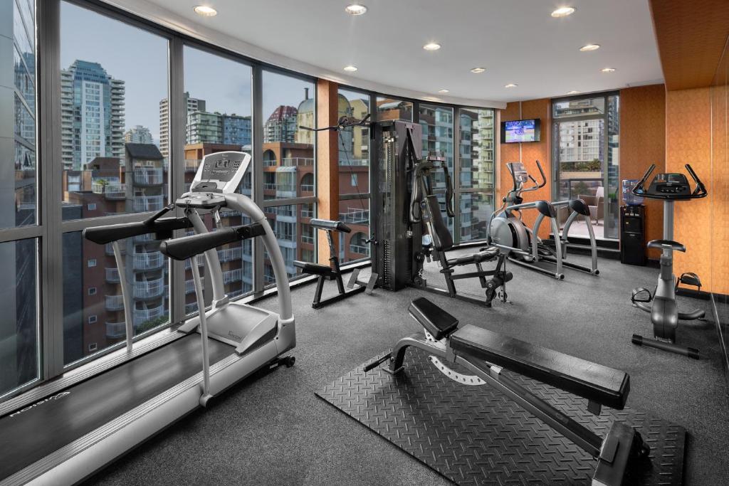 a gym with treadmills and machines in a building at Executive Hotel Vintage Park in Vancouver
