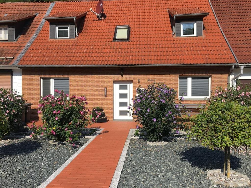 a brick house with a red roof at Holiday home in Elbingerode with garden in Rübeland