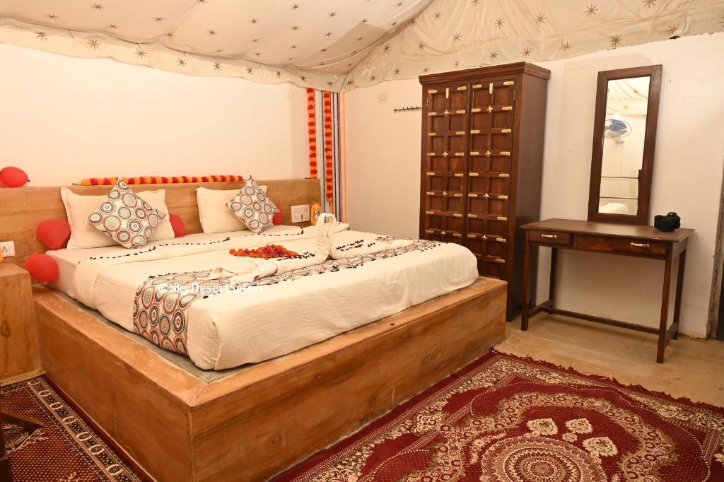 a bedroom with a large bed and a table at Sky Desert Safari in Sām