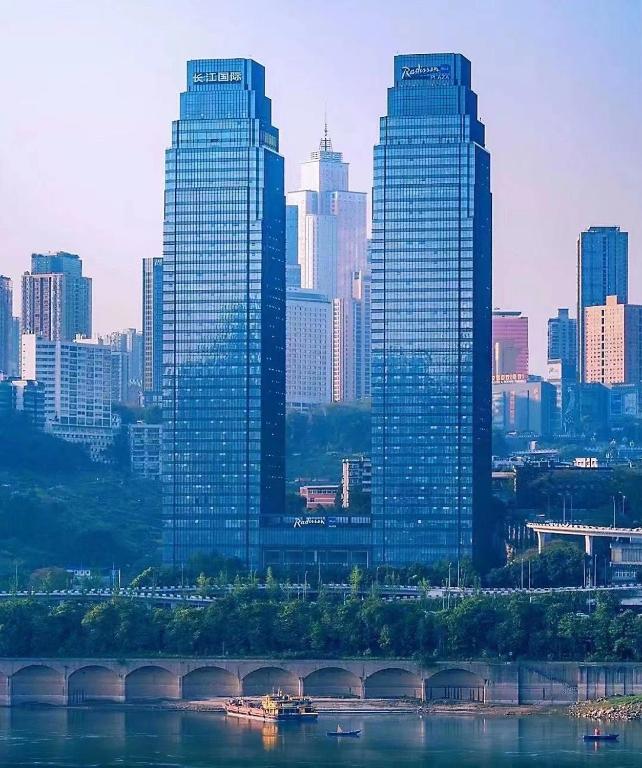 a city skyline with tall buildings and a bridge at Radisson Blu Plaza Chongqing in Chongqing