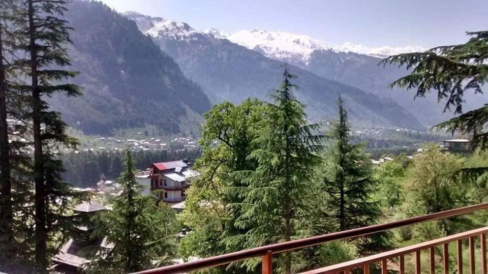 a view from a balcony of a house in the mountains at Guruchhaya hotel and cottages in Manāli