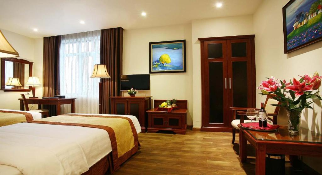 Postel nebo postele na pokoji v ubytování Western Hanoi Hotel