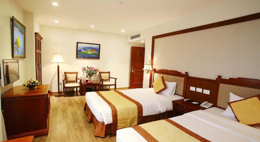 Postel nebo postele na pokoji v ubytování Western Hanoi Hotel