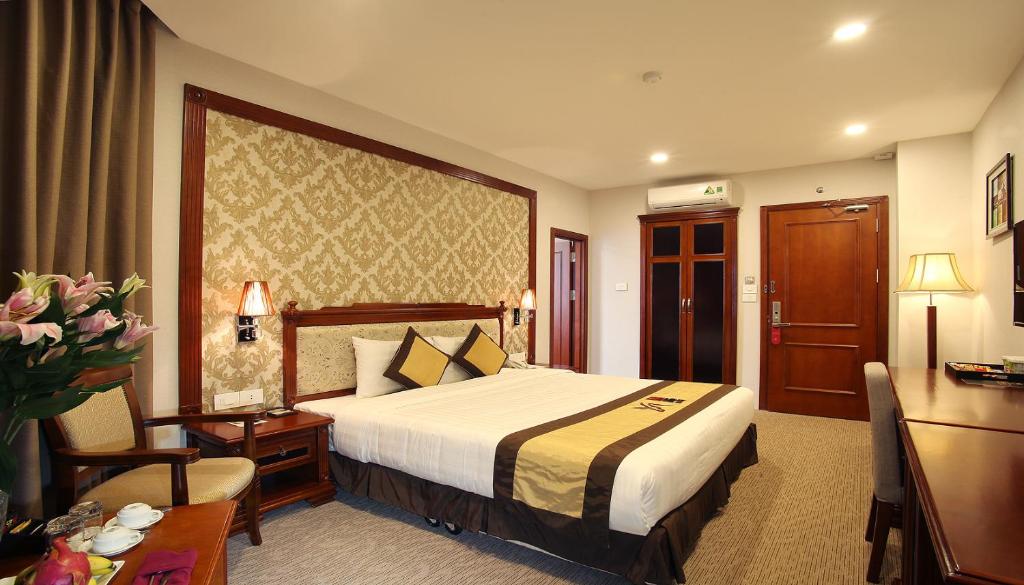 Postel nebo postele na pokoji v ubytování Western Hanoi Hotel