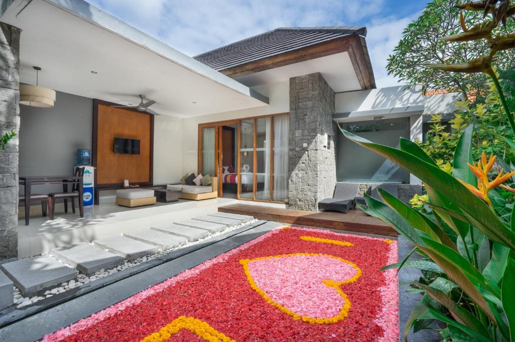 a house with a red carpet in the front yard at Samaja Villas Seminyak in Seminyak