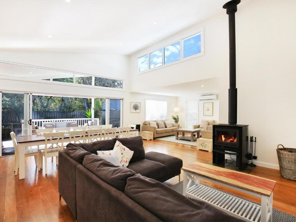 a living room with a couch and a fireplace at Calming Waters - Pet Friendly - Community Pool in Callala Beach