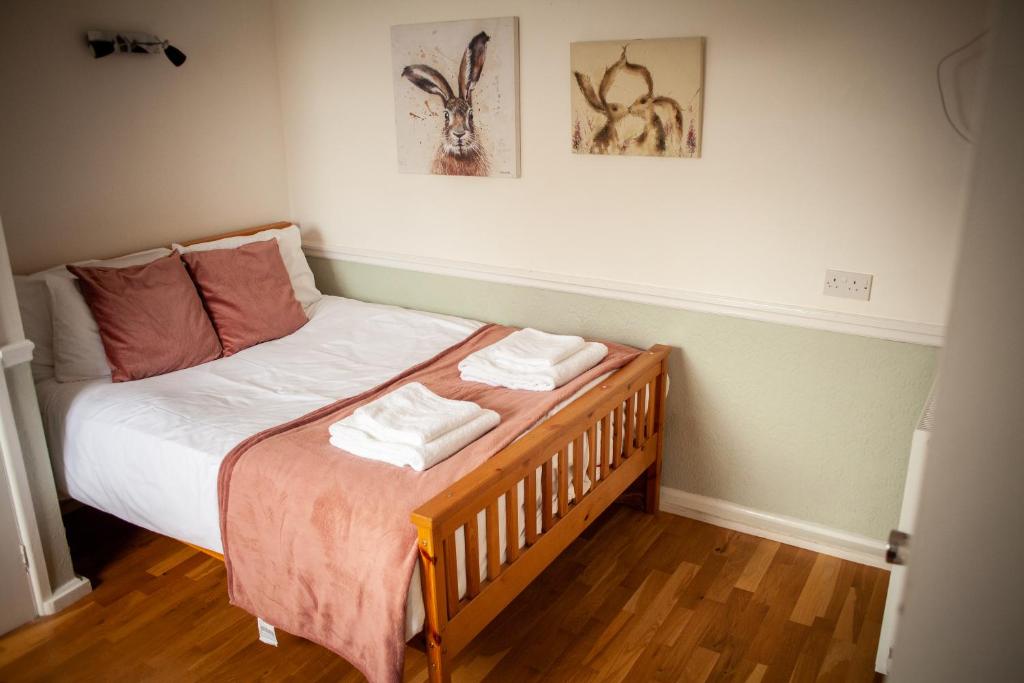 a bedroom with a bed with two towels on it at The Chagford Inn in Chagford