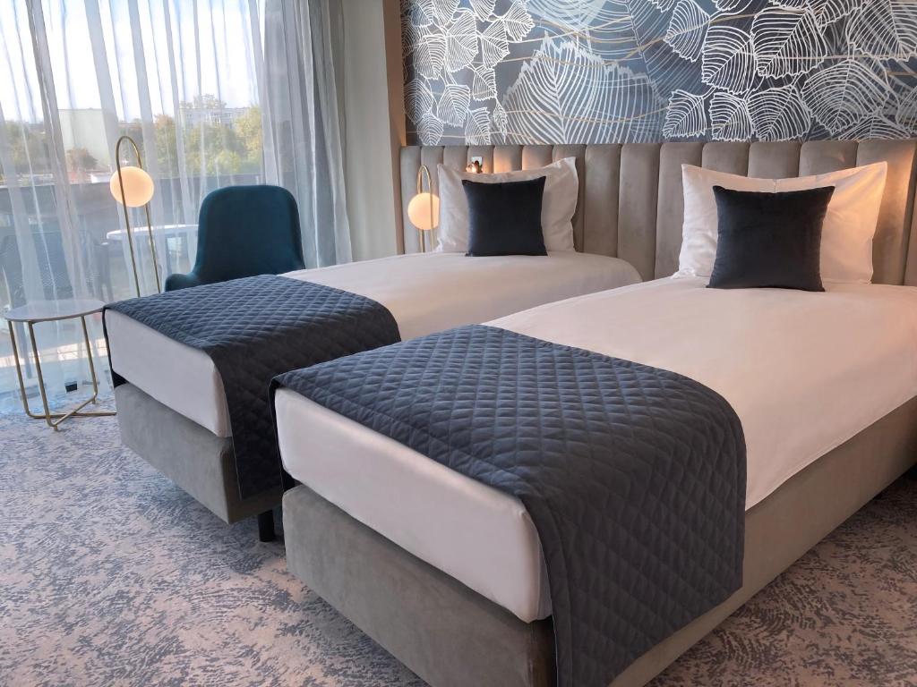 A bed or beds in a room at Tisia Hotel & Spa