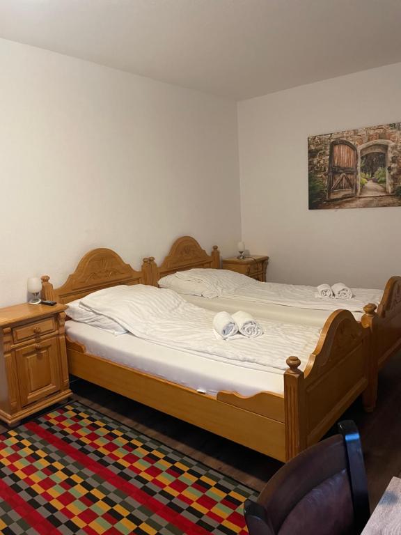 a bedroom with a large bed with white sheets at Lippborger-Hof in Lippetal