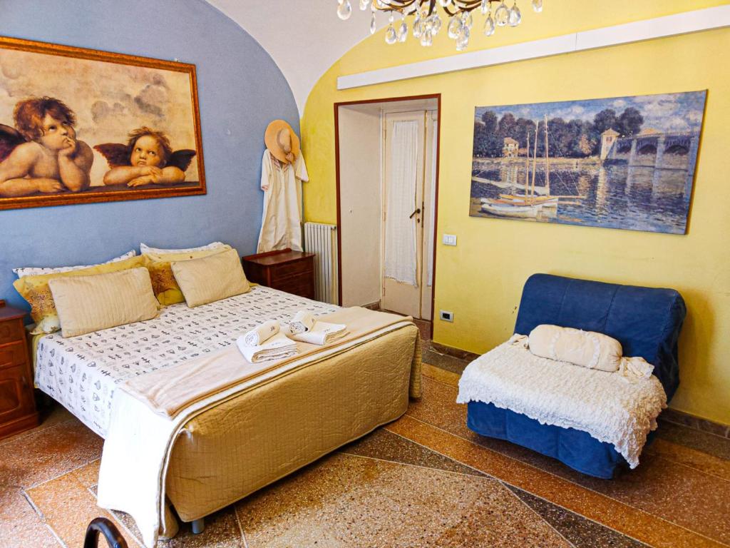 a bedroom with a bed and a chair in it at Nar&igrave; Bed&Breakfast in Gaeta