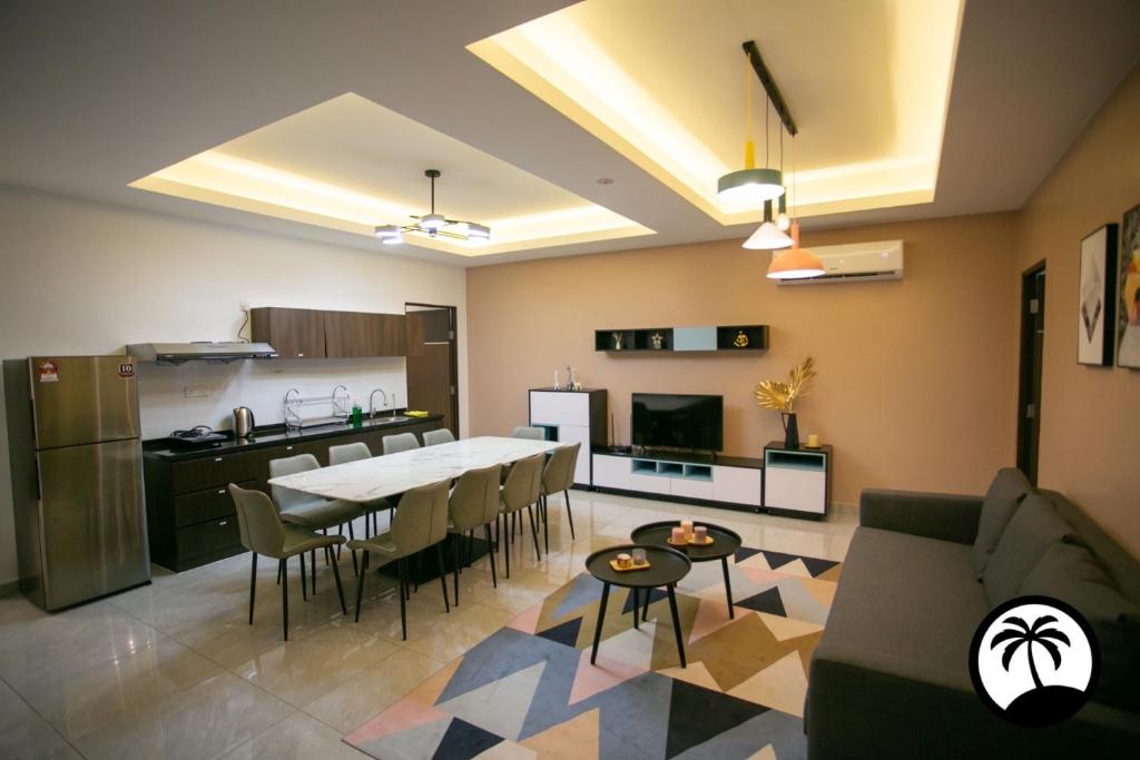 a kitchen and living room with a table and chairs at Paradise Suite at KK Times Square, beside Imago in Kota Kinabalu