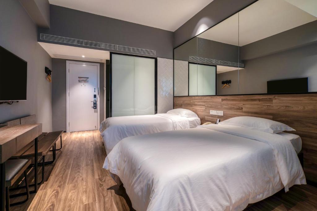 Postel nebo postele na pokoji v ubytování 有集城市客栈锦绣中华店Unijoy Cityinn Splendid China Shenzhen