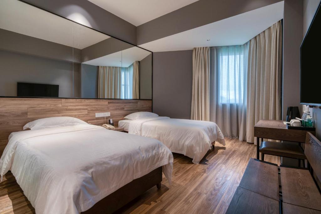 Postel nebo postele na pokoji v ubytování 有集城市客栈锦绣中华店Unijoy Cityinn Splendid China Shenzhen