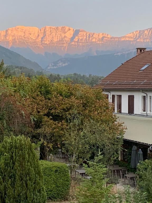 a house with a view of a mountain in the background at Au Sans Souci in Saint-Paul-lès-Monestier