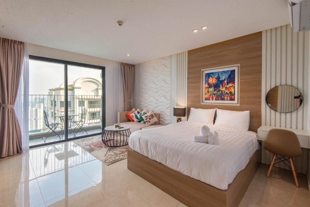 a bedroom with a large bed and a balcony at 22Housing Vinhomes D'Capitale Hotel & Residence in Hanoi