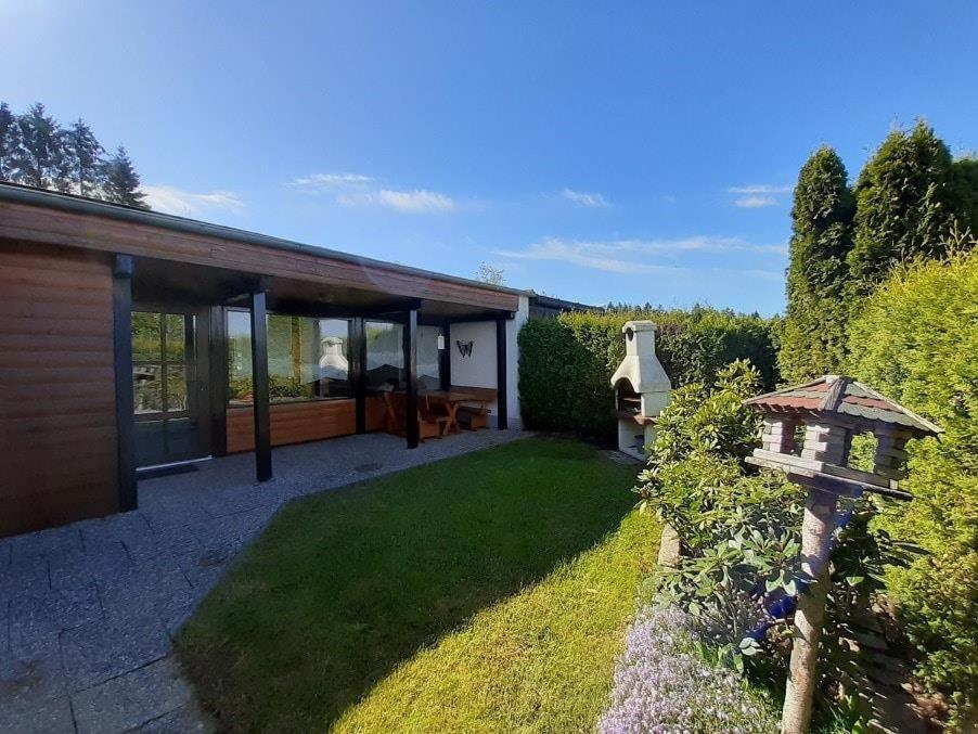 una casa con giardino e casetta per uccelli di Ferienhaus Bayerwald am Erlauzwieseler See a Waldkirchen