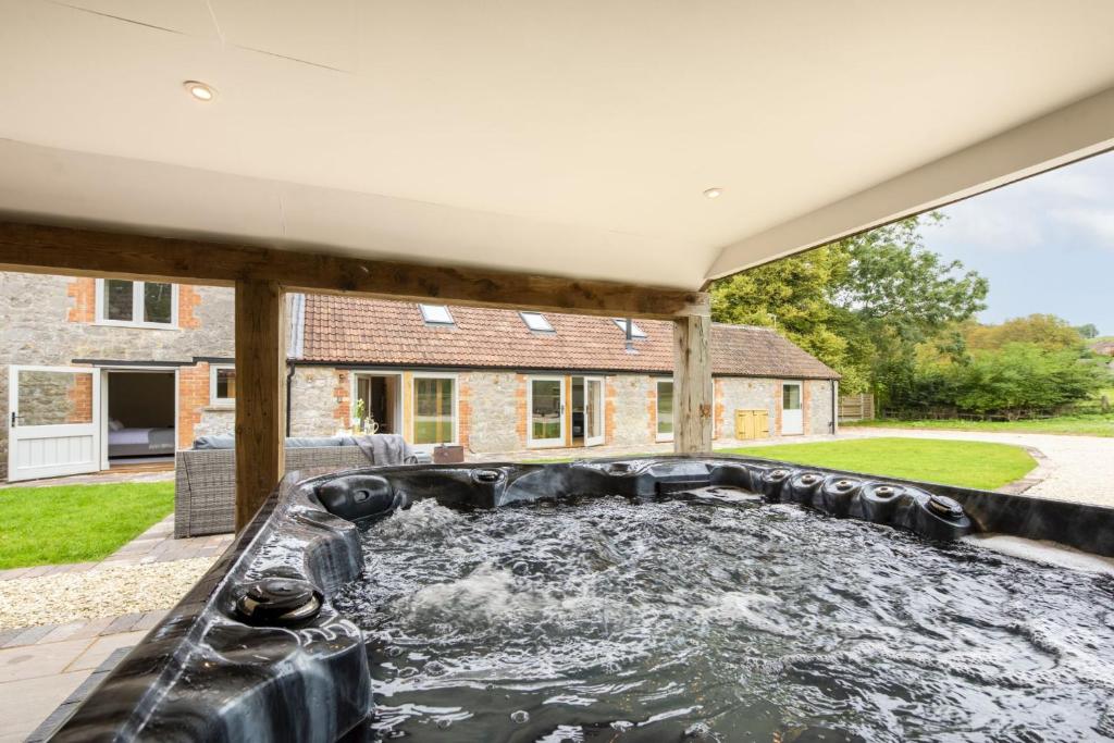 a pond in the backyard of a house at The Cowshed in Brent Knoll