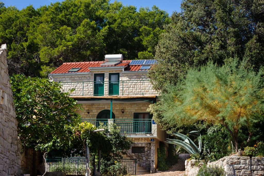 an old house with solar panels on its roof at House Ivo in Stomorska