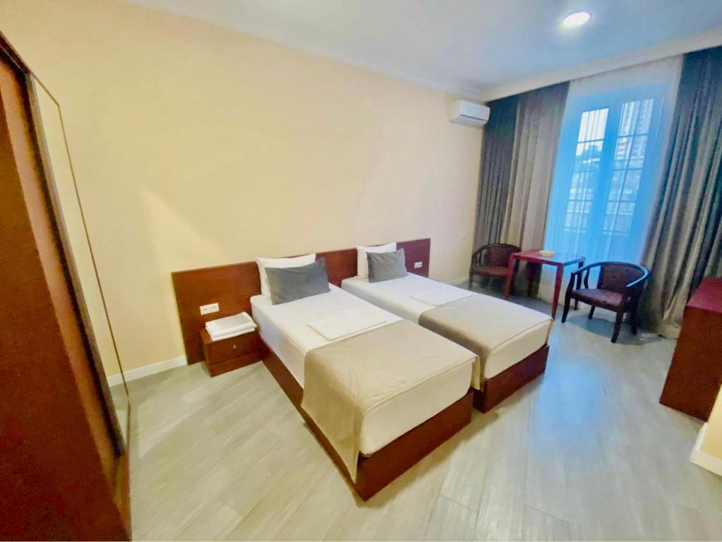 Postel nebo postele na pokoji v ubytování Grand Fortune Hotel