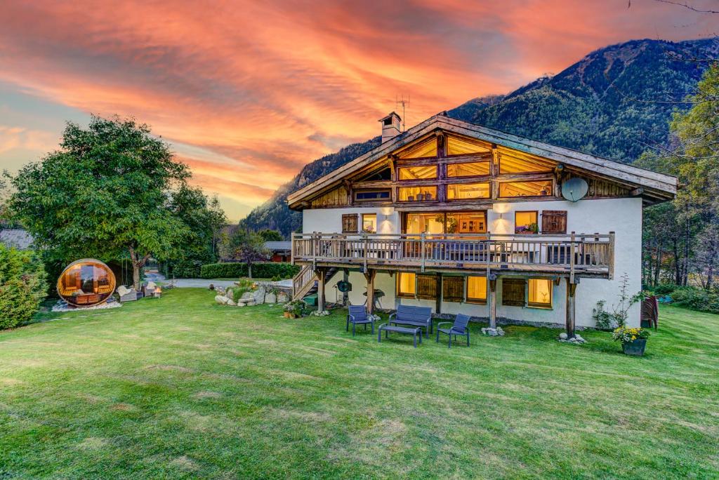 a large house with a deck on a yard at Chalet Tissi&egrave;res in Chamonix-Mont-Blanc